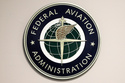 FILE - A Federal Aviation Administration sign hangs in the tower at John F. Kennedy International Airport in New York, March 16, 2017. (AP Photo/Seth Wenig, File)
