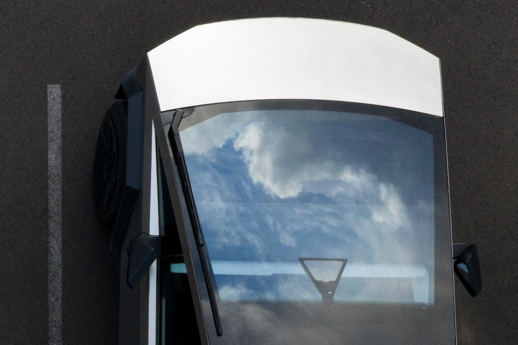 Clouds are reflected on a Tesla cybertruck at a Tesla facility Wednesday, April 15, 2026, in Portland, Ore. (AP Photo/Jenny Kane)