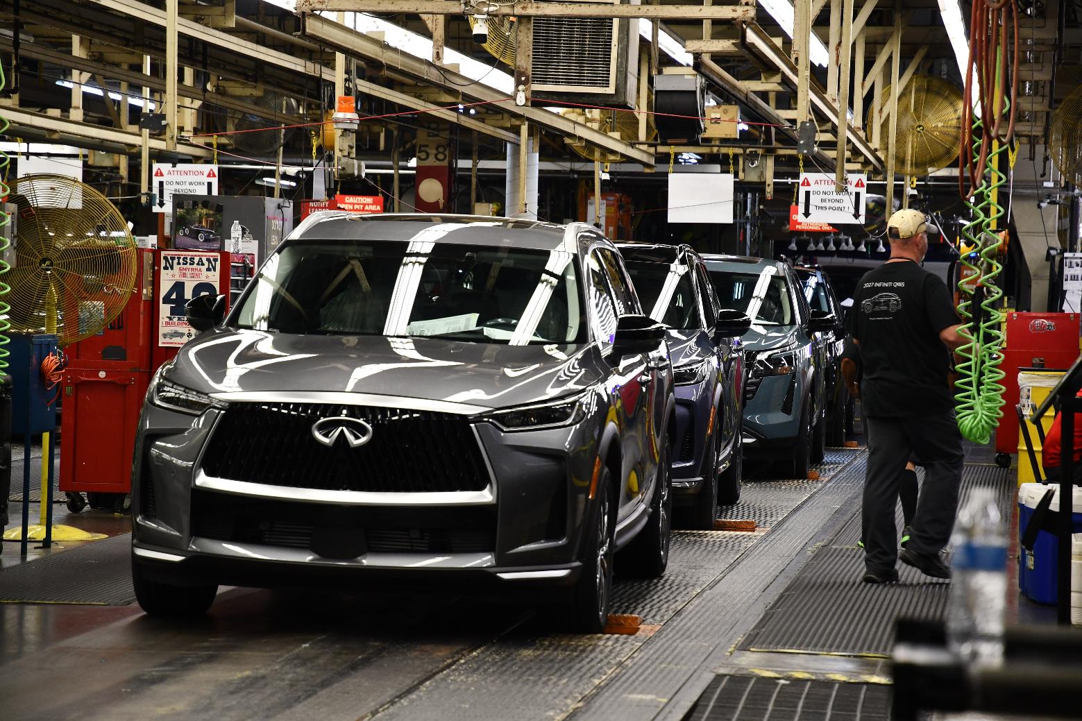 A worker walks past a line of Infiniti SUVs on a production line at the Nissan Smyrna Vehicle Assembly Plant, Thursday, April 16, 2026, in Smyrna, Tenn. (AP Photo/Kristin M. Hall)