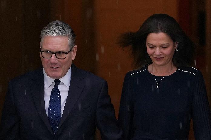 Britain's Prime Minister Keir Starmer and wife Victoria leave 10 Downing Street to attend the State Opening of Parliament at the Houses of Parliament in London, Wednesday, May 13, 2026.(AP Photo/Alberto Pezzali)