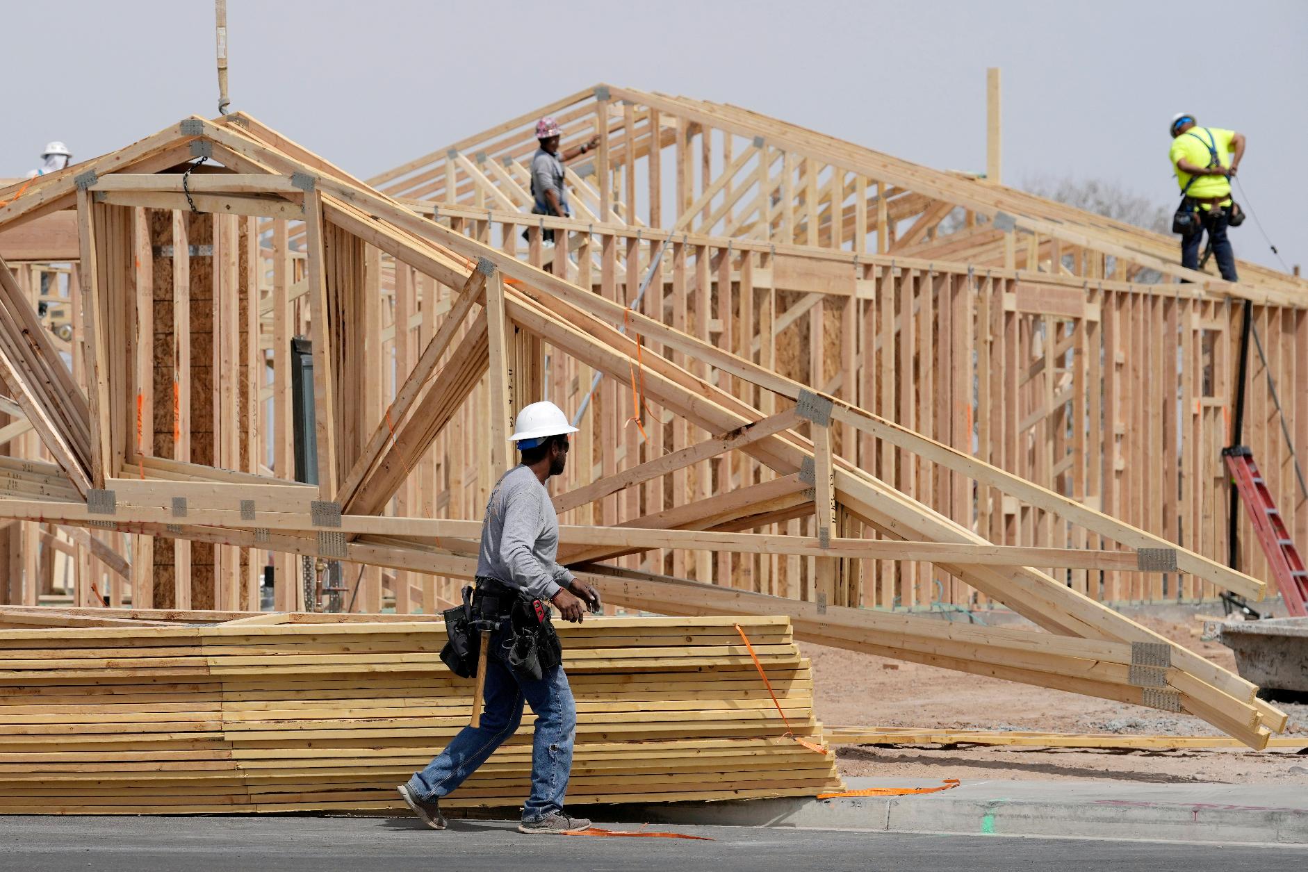 FILE - Construction workers install a lumber roof at a new home build Tuesday, April 1, 2025, in Laveen, Ariz. (AP Photo/Ross D. Franklin, File)