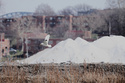 A seagull flies past piles of the finished product, de-icing solution - rock salt - at the Cargill Cleveland salt mine on Whiskey Island before being distributed by truck, rail and boat to Ohio, Pennsylvania, New York, Indiana and Minnesota, in Cleveland, Ohio, Thursday, March 19, 2026. (AP Photo/Sue Ogrocki)