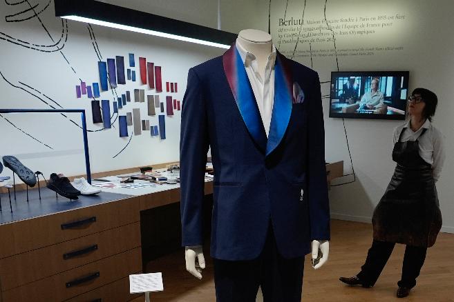 A Berluti suit designed to be worn by French athletes during the opening is displayed inside the LVMH Pavilion, showcasing creations of the French luxury brand related to the Paris 2024 Summer Olympics, Monday, July 22, 2024, in Paris. (AP Photo/Rebecca Blackwell)