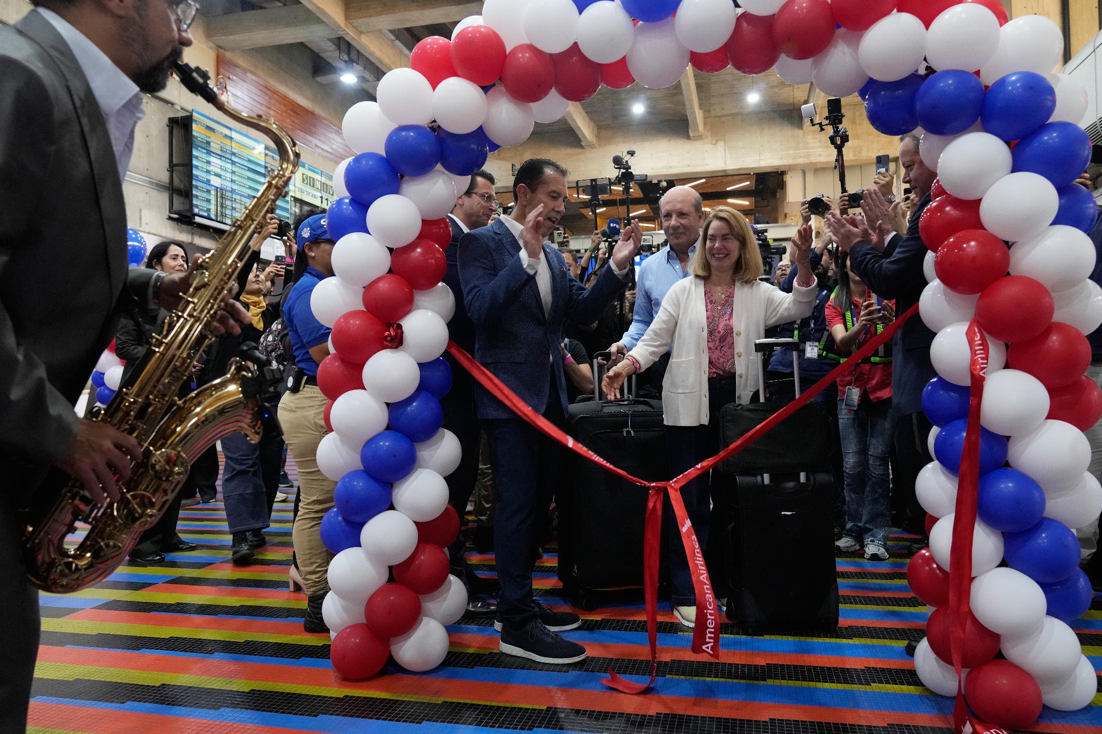 Passengers line up to check in for a U.S.-bound commercial flight at Simon Bolivar International Airport in Maiquetia, Venezuela, Thursday, April 30, 2026, as direct air service between the United States and Venezuela resumes after seven years. (AP Photo/Ariana Cubillos)