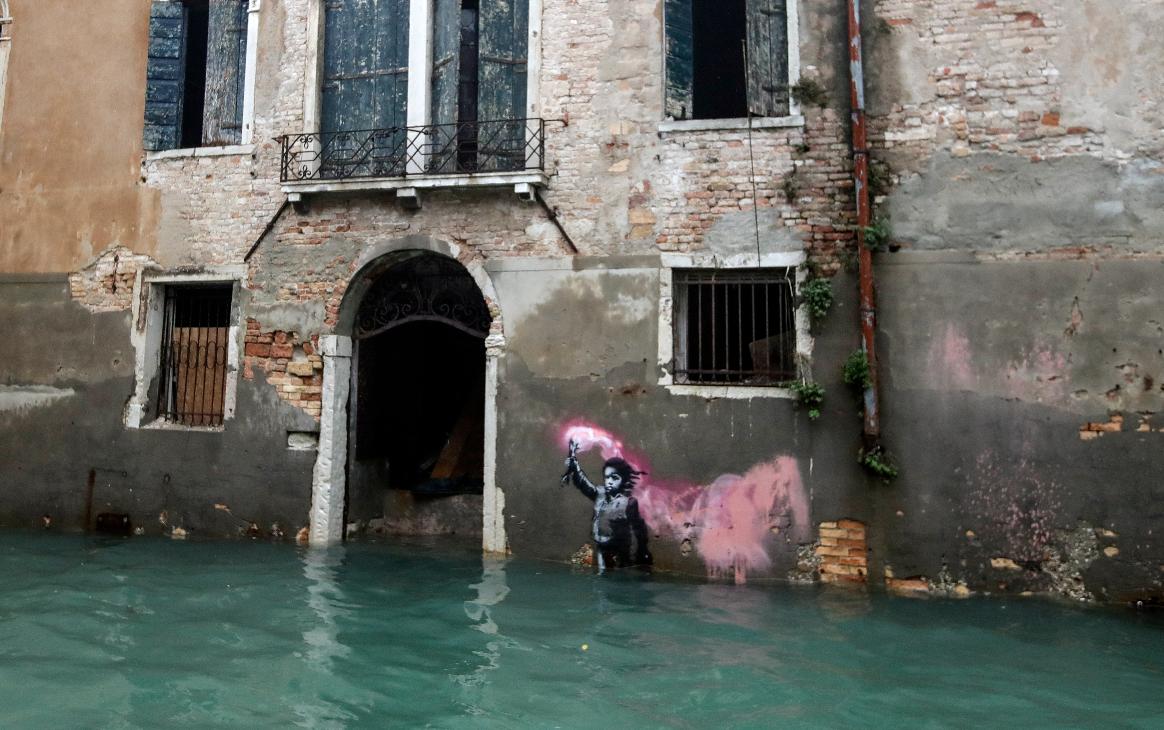 FILE - The Bansky work 'The Migrant Child' is partially submerged in Venice, Italy, Nov. 15, 2019. (AP Photo/Luca Bruno, File)