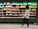 FILE - A shopper peruses cheese offerings at a Target store Wednesday, Oct. 4, 2023, in Sheridan, Colo. (AP Photo/David Zalubowski, File)