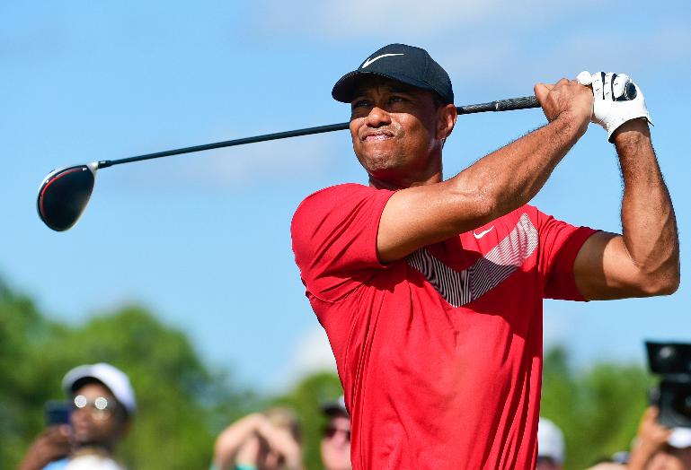 FILE - Tiger Woods follows his ball at the fourth tee during the last round of the Hero World Challenge at Albany Golf Club in Nassau, Bahamas, on Dec. 7, 2019. Woods is starting a new year with a new look. Just not a different color. Woods makes his 2024 debut this week in the Genesis Invitational at Riviera, a signature event on the PGA Tour in which he is the tournament host. The first order of business is unveiling what he referred to in December as the next “chapter.” (AP Photo/Dante Carrer, File)
