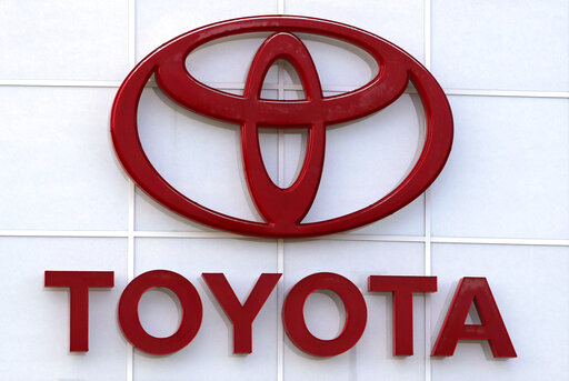 FILE - The Toyota logo on a dealership is seen in Manchester, N.H. on Aug. 15, 2019. Toyota plan to resume production at all of its 14 plants as of Wednesday, March 2, 2022, after they were idled for a day due to a cyberattack on a domestic supplier.   (AP Photo/Charles Krupa, File)