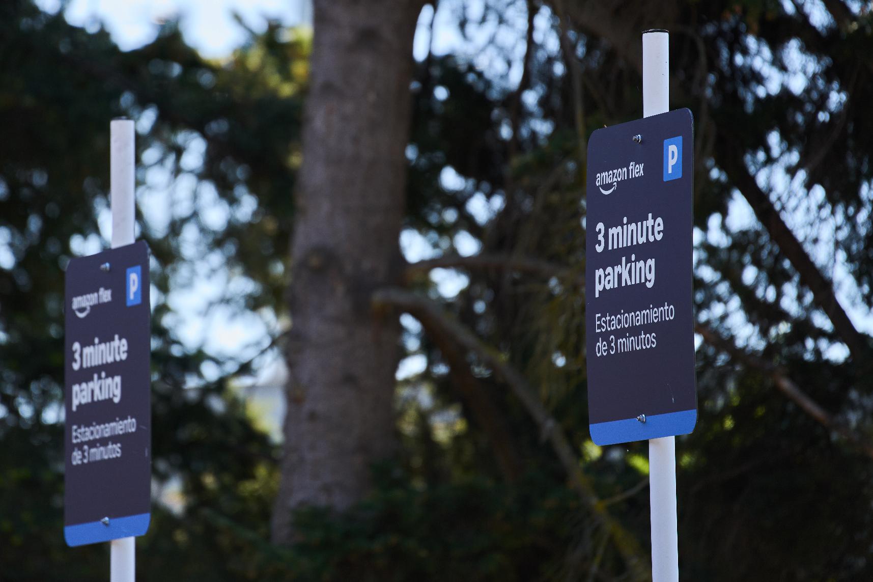 Parking signage for drivers stands outside an Amazon Now location, Monday, May 11, 2026, in Bellevue, Wash. (AP Photo/Lindsey Wasson)