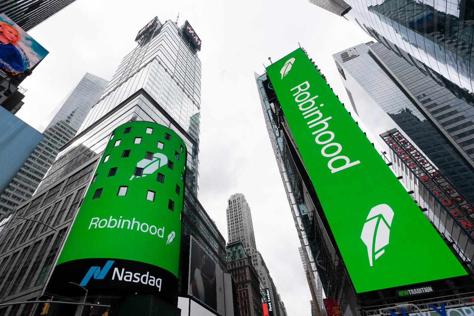 FILE - Electronic screens in New York's Times Square announce the Robinhood IPO, July 29, 2021. Robinhood Markets Inc. is buying crytocurrency exchange Bitstamp, Thursday, June 6, 2024, for about $200 million as the company looks to speed up its cryptocurrency expansion globally. (AP Photo/Mark Lennihan, File)