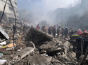 Rescue workers search for victims at the site of an Israeli airstrike that hit a crowded neighbourhood south of Beirut, Lebanon, Sunday, April 5, 2026. (AP Photo/Hussein Malla)