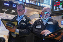 Traders Edward Curran, left, and Fred Demarco work on the floor of the New York Stock Exchange, Wednesday, June 3, 2026. (AP Photo/Richard Drew)