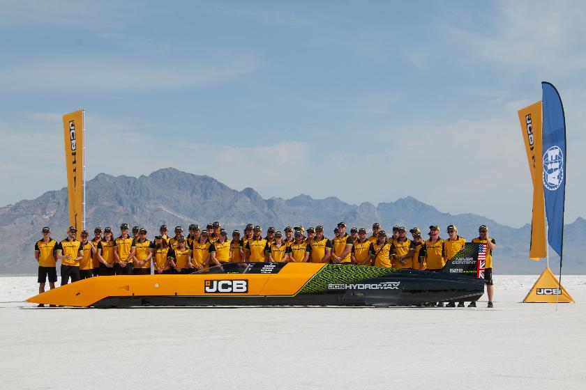 British driver Andy Green and the JCB engineering team pose with the car used to set a new land speed record for a hydrogen-powered vehicle, Tuesday, Aug. 11, 2026, at the Bonneville Salt Flats in Utah. (AP Photo/Hannah Schoenbaum)