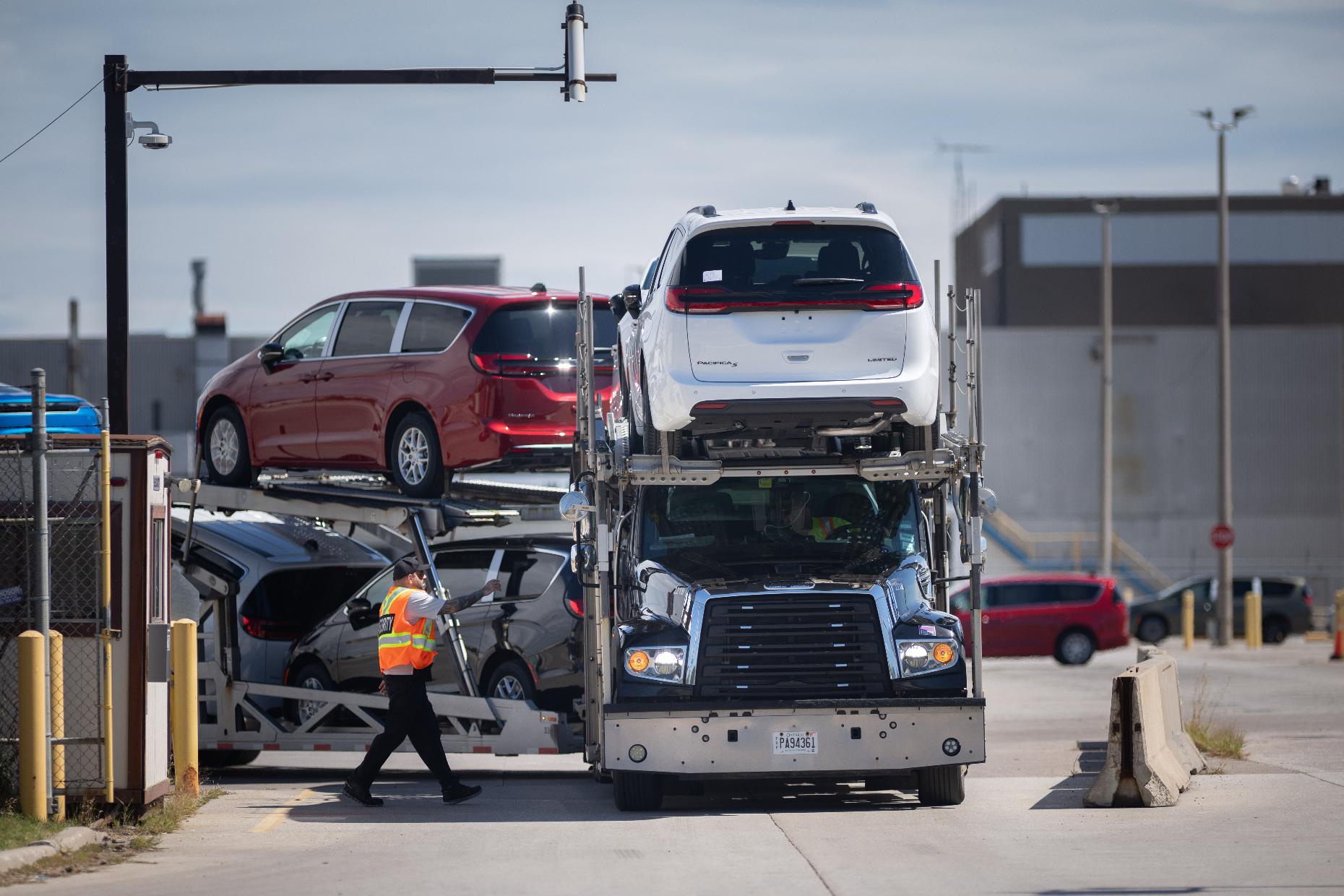 A transport truck carrying Chrysler Pacificas leaves the Windsor Assembly Plant, in Windsor, Ontario, Canada, on Monday, Aug. 24, 2026. (Dax Melmer/The Canadian Press via AP)