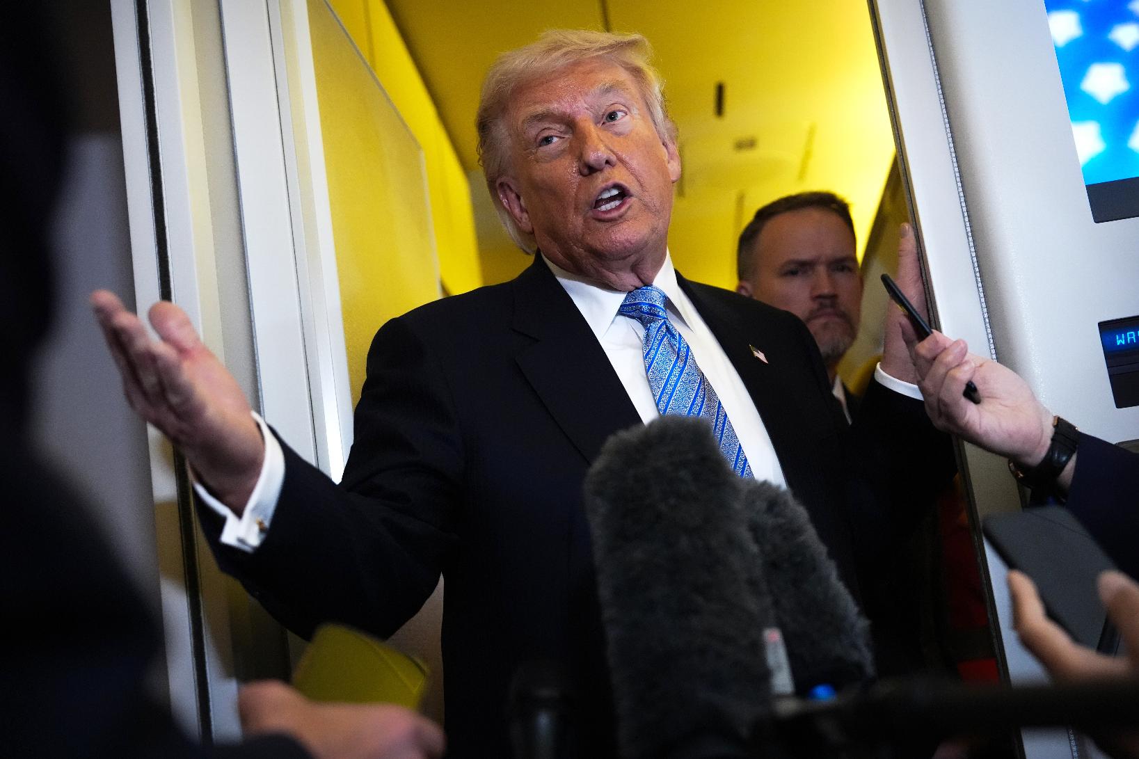 President Donald Trump speaks to reporters aboard Air Force One, Friday, May 15, 2026, as he returns from a trip to Beijing, China. (AP Photo/Mark Schiefelbein)