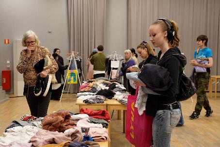 Alva Palosaari Sundman, right, checks out secondhand clothes at a clothing swap event in Stockholm, Sweden, Saturday, April 19. 2026. (AP Photo/Chisato Tanaka)