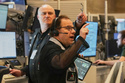 Options trader Anthony Spina, foreground, works on the floor of the New York Stock Exchange, Thursday, April 30, 2026. (AP Photo/Richard Drew)