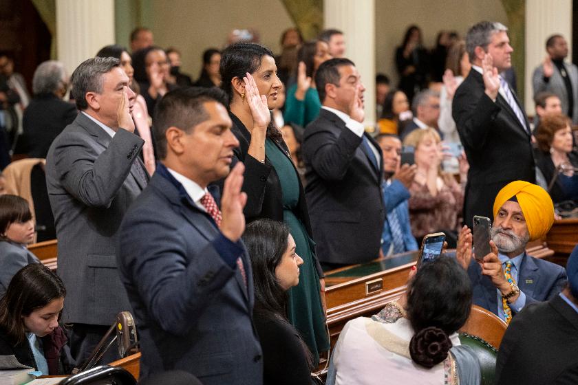 Assemblymember Dr. Jazmeet Bains, center, of District 35, and other assembly members take the oath during the opening session of the California Legislature in Sacramento, Calif., Monday, Dec. 5, 2022. The legislature returned to work to swear in new members and elect leaders for the upcoming session. (AP Photo/José Luis Villegas, Pool)