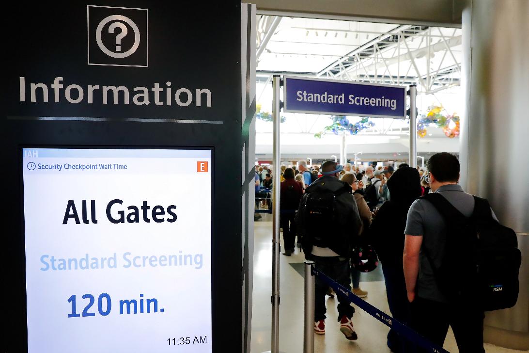 Air travelers endure long lines and two-hour wait times at the TSA security check point at Terminal E at the George Bush Intercontinental Airport Friday, March 20, 2026, in Houston. (AP Photo/Michael Wyke)