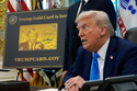 FILE - A poster showing the Trump Gold Card is seen as President Donald Trump signs executive orders in the Oval Office of the White House, Sept. 19, 2025, in Washington. (AP Photo/Alex Brandon, File)