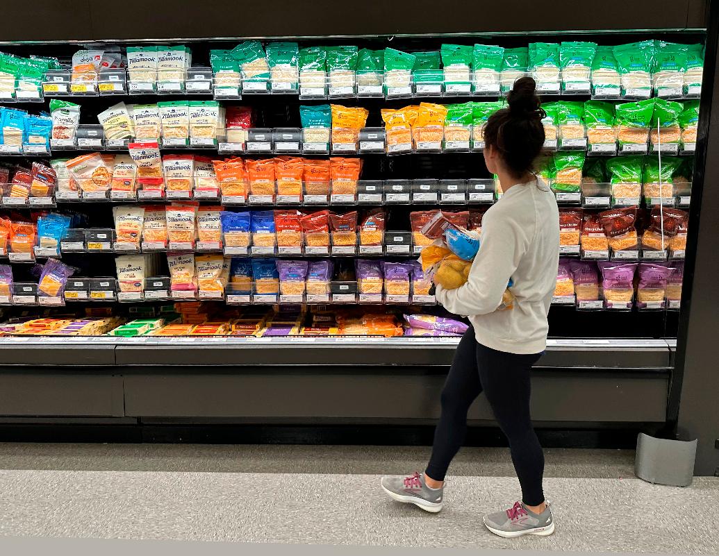 FILE - A shopper peruses cheese offerings at a Target store Wednesday, Oct. 4, 2023, in Sheridan, Colo. (AP Photo/David Zalubowski, File)