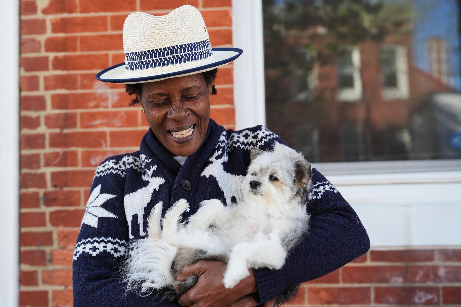 Jevona Anderson, a student at the University of Baltimore, poses for a portrait with her dog, Bella, Tuesday, April 7, 2026, in Baltimore. (AP Photo/Stephanie Scarbrough)