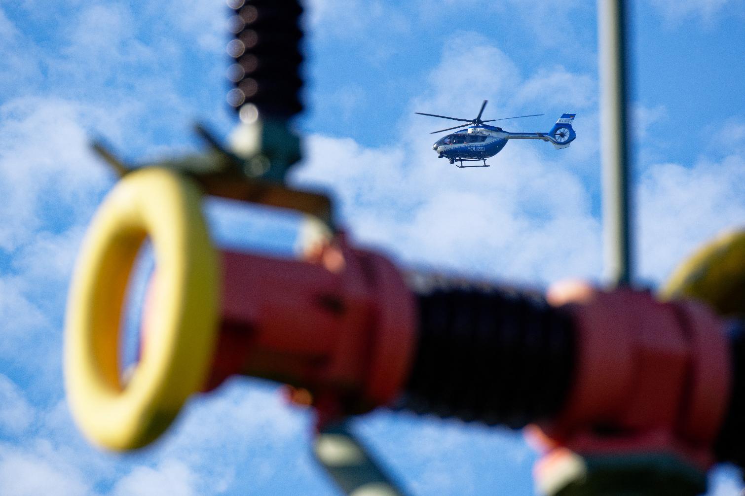 A police helicopter is circling above the Amprion substation in Bergheim, Germany, Wednesday, Sept. 2, 2026. (Henning Kaiser/dpa via AP)