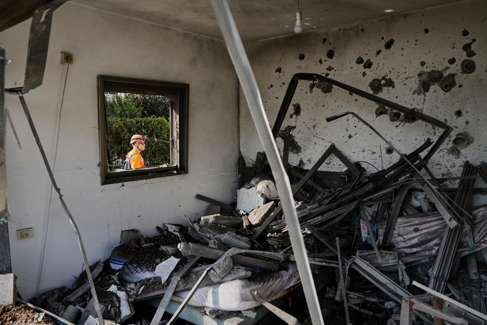 Israeli authorities inspect homes damaged by a projectile launched from Lebanon, in Haniel, central Israel, Thursday, March 12, 2026. (AP Photo/Baz Ratner)