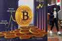 FILE - An advertisement for Bitcoin cryptocurrency is displayed on a street in Hong Kong, on Feb. 17, 2022. Europe is poised to take the global lead in regulating the freewheeling cryptocurrency industry at a time when prices have plunged, wiping out fortunes, fueling skepticism and sparking calls for tighter scrutiny. European Union negotiators were set to hold talks on Thursday, June 30, 2022, to hammer out the final details in the bloc's sweeping package of crypto rules. (AP Photo/Kin Cheung, File)