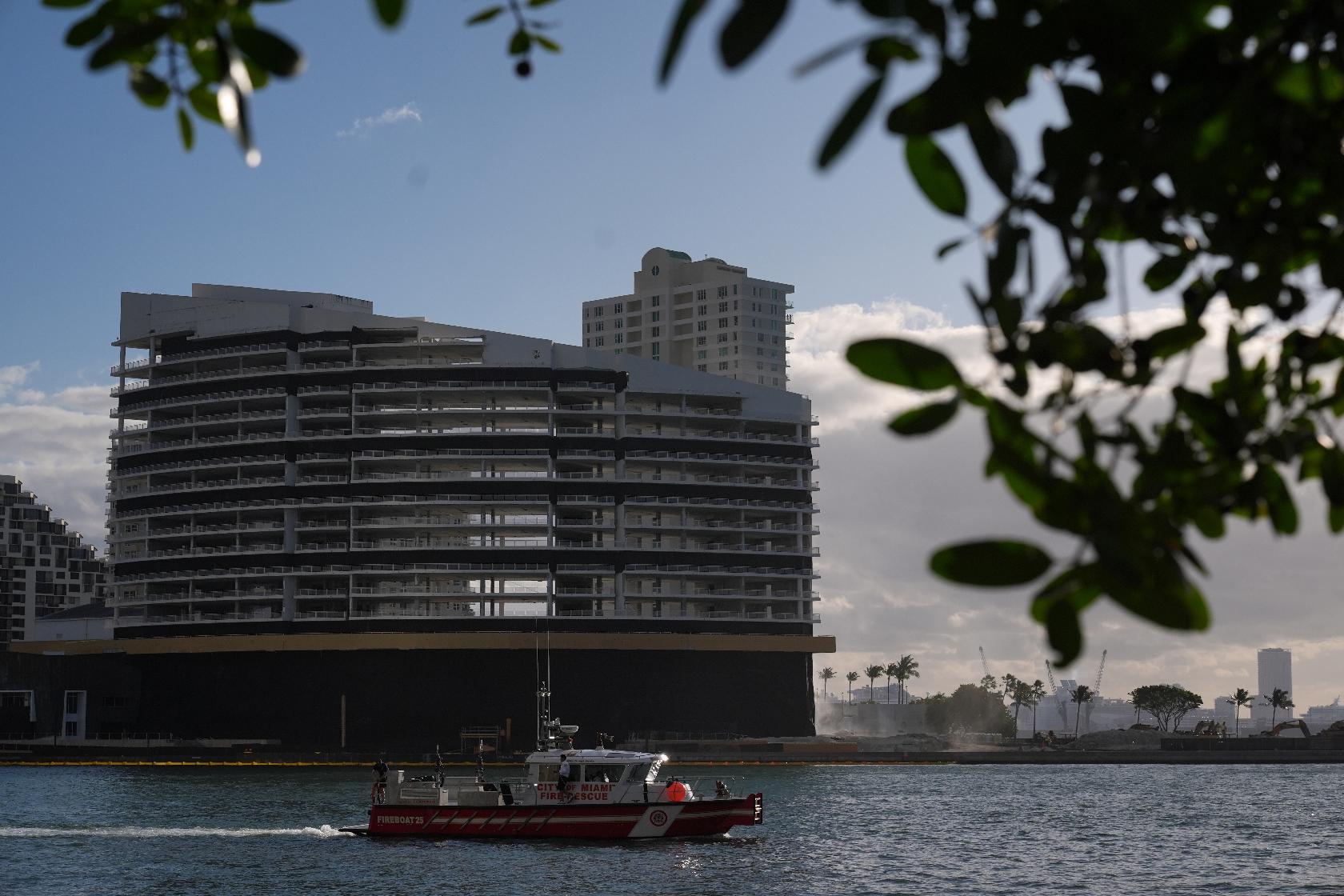 A City of Miami Fire-Rescue boat patrols in front of the former Mandarin Oriental Hotel on Brickell Key ahead of its controlled implosion, Sunday, April 12, 2026, in Miami. (AP Photo/Rebecca Blackwell)