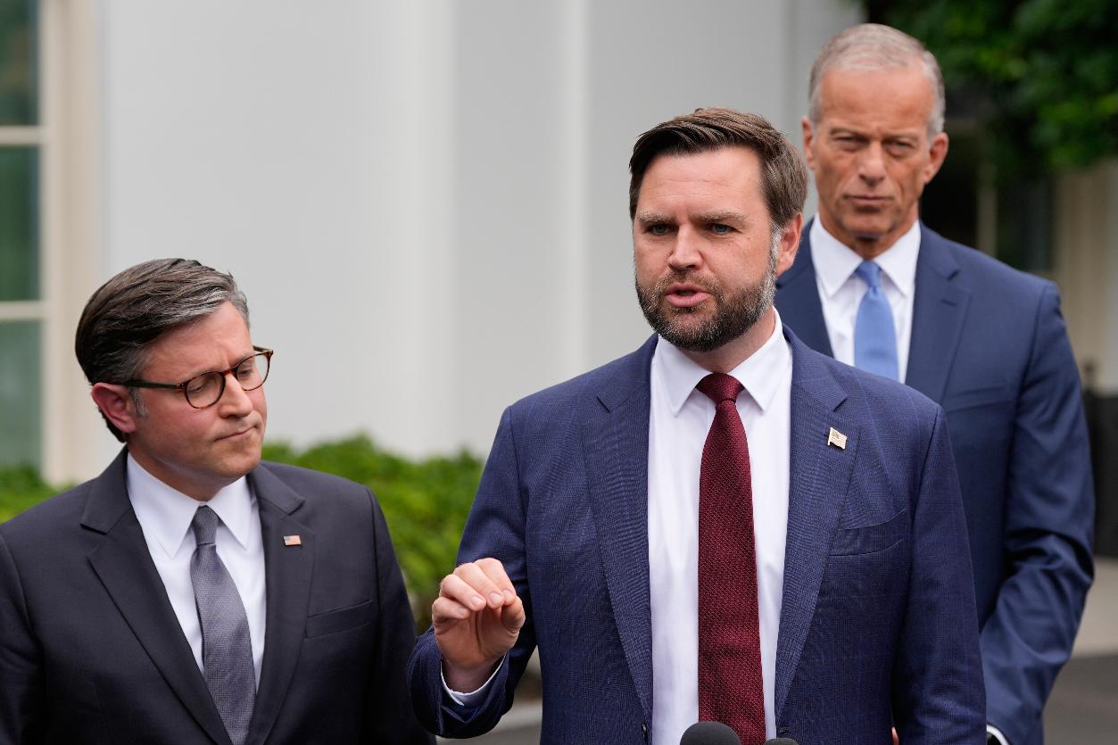 Vice President JD Vance talks to reporters outside the West Wing of the White House, Monday, Sept. 29, 2025, in Washington, as House Speaker Mike Johnson of La., and Senate Majority Leader John Thune, R-S.D., listen. (AP Photo/Alex Brandon)