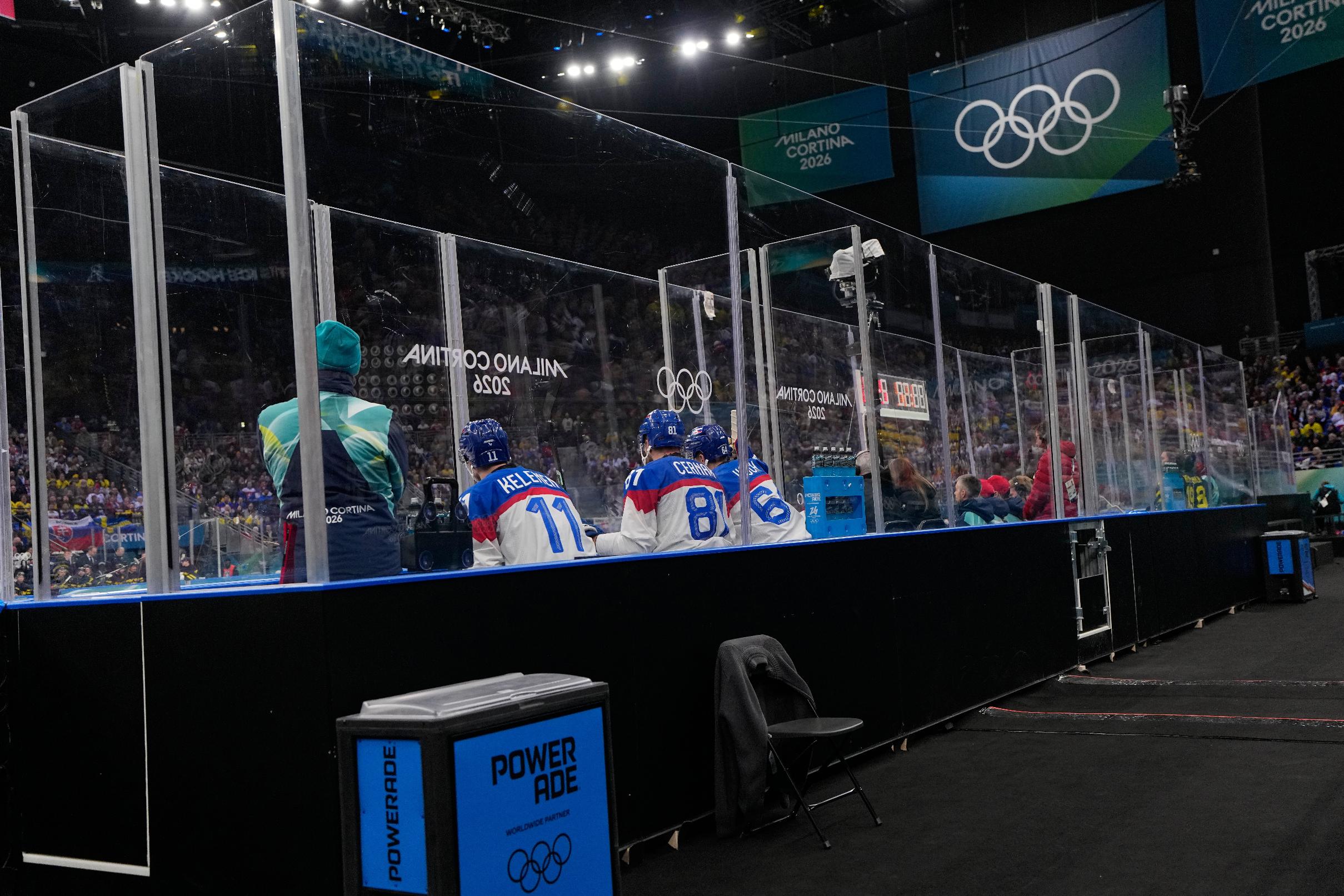 Slovakia's Milos Kelemen, left, Slovakia's Erik Cernak, center, and Slovakia's Patrik Koch sit in the penalty box during a preliminary round match of men's ice hockey between Sweden and Slovakia at the 2026 Winter Olympics, in Milan, Italy, Saturday, Feb. 14, 2026. (AP Photo/Petr David Josek)