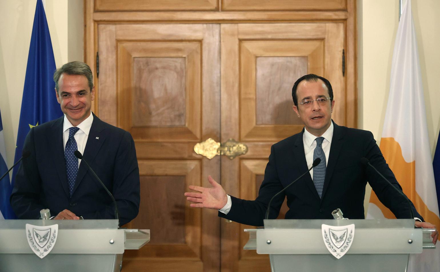 Cyprus' President Nikos Christodoulides, right, and Greek Prime Minister Kyriakos Mitsotakis address the media, during a press conference after their meeting at the Presidential Palace in Nicosia, Cyprus, on Monday, July 31, 2023. Mitsotakis is in Cyprus on an official visit. (Yiannis Kourtoglou Pool via AP)