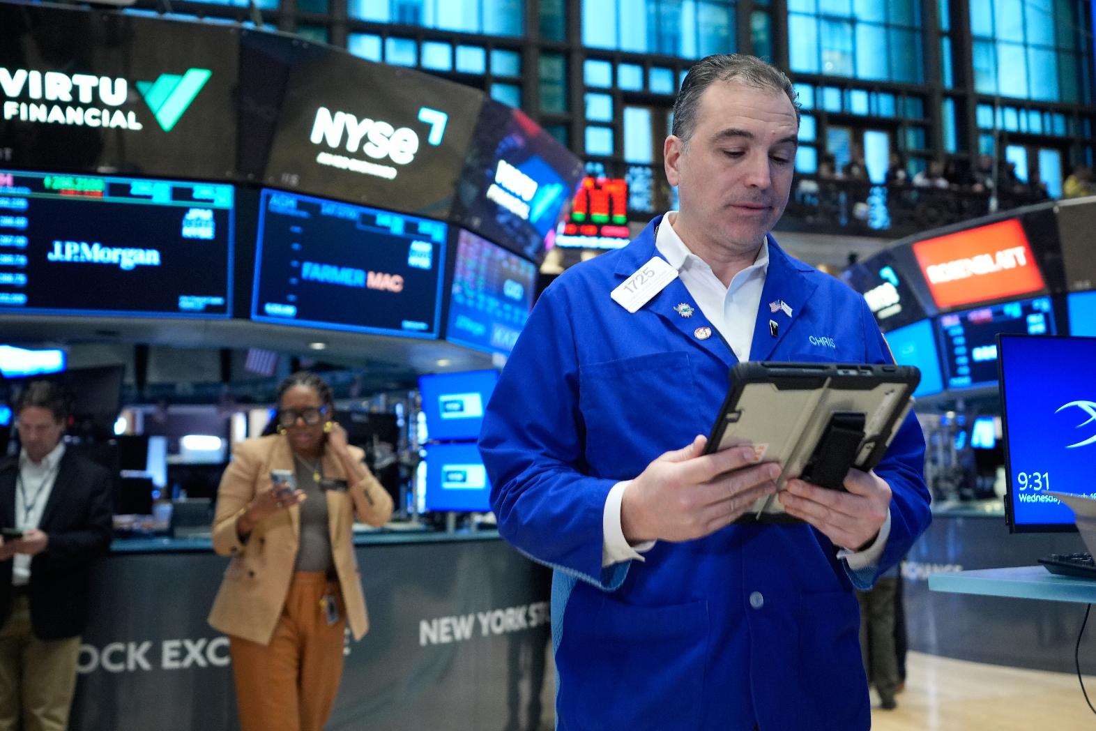Christopher Lagana works on the floor at the New York Stock Exchange in New York, Wednesday, March 18, 2026. (AP Photo/Seth Wenig)