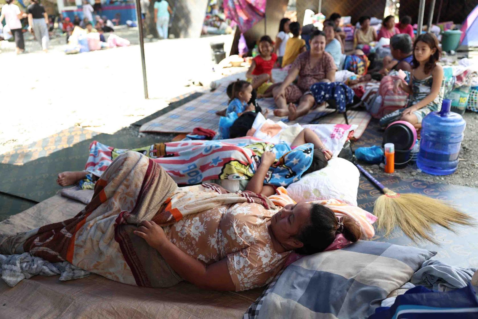 Residents take shelter in a field at a municipal hall in Sarangani province, Philippines, Wednesday, June 10, 2026. (AP Photo/Basilio Sepe)
