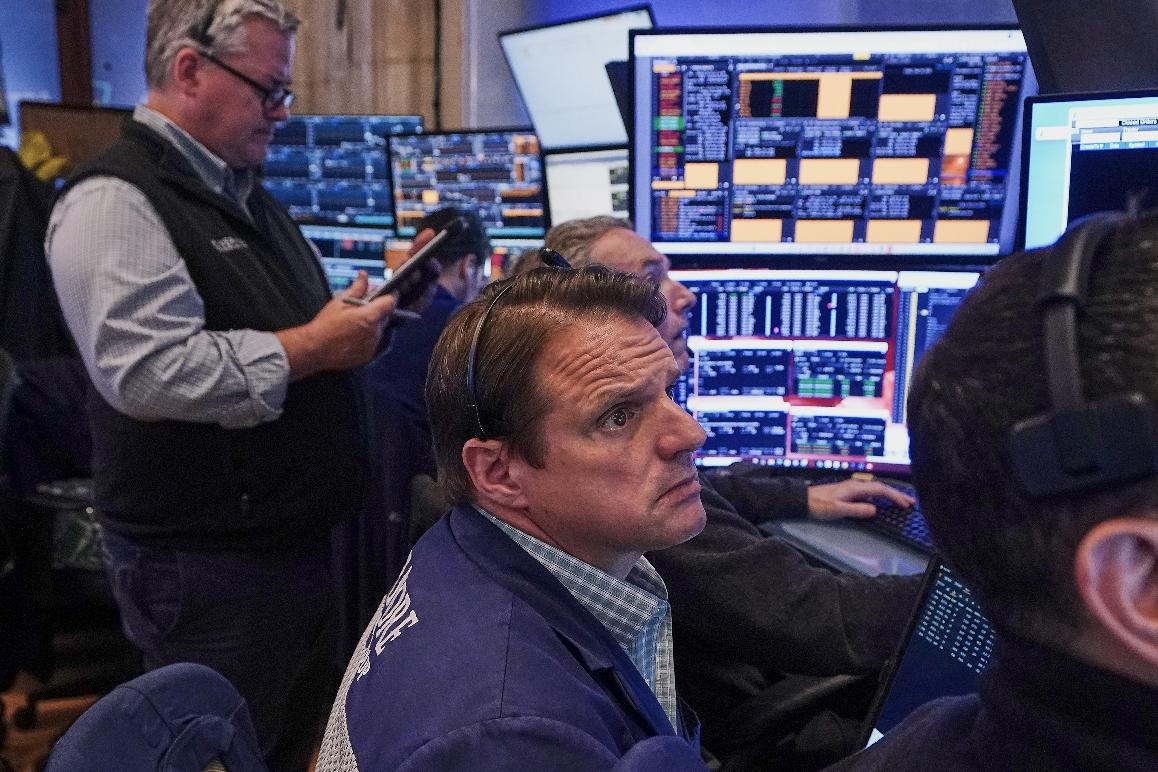 Trader Michael Milano, center, works on the floor of the New York Stock Exchange, Friday, June 26, 2026. (AP Photo/Richard Drew)