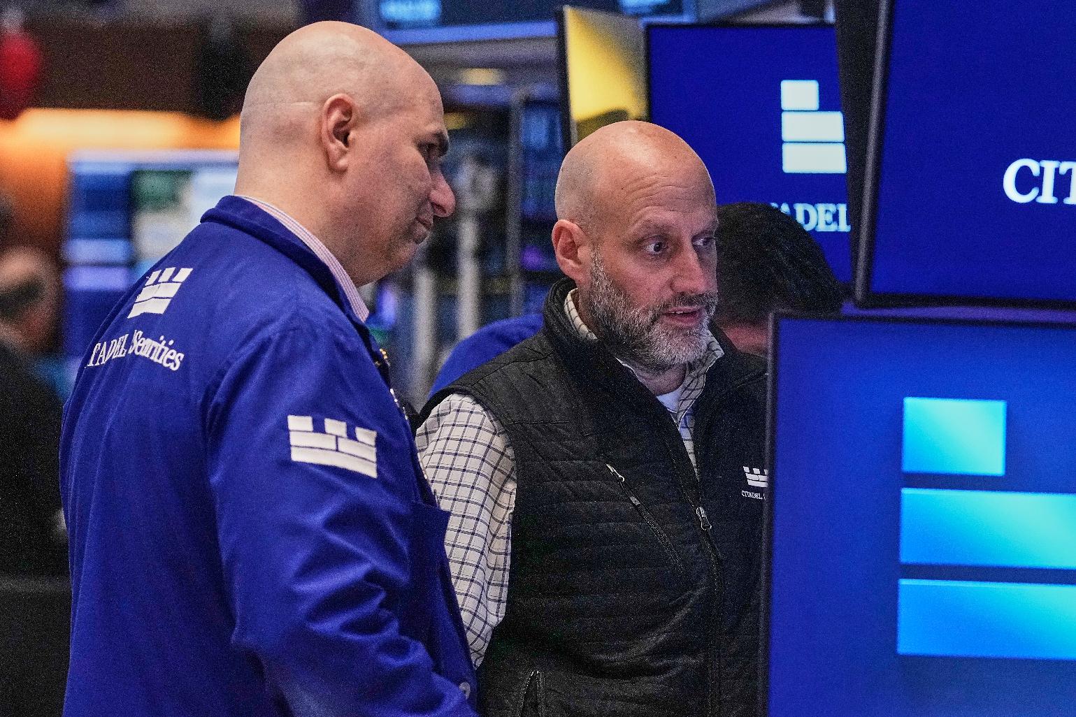 Specialists Philip Finale, left, and Meric Greenbaum work on the floor of the New York Stock Exchange, Friday, May 29, 2026. (AP Photo/Richard Drew)