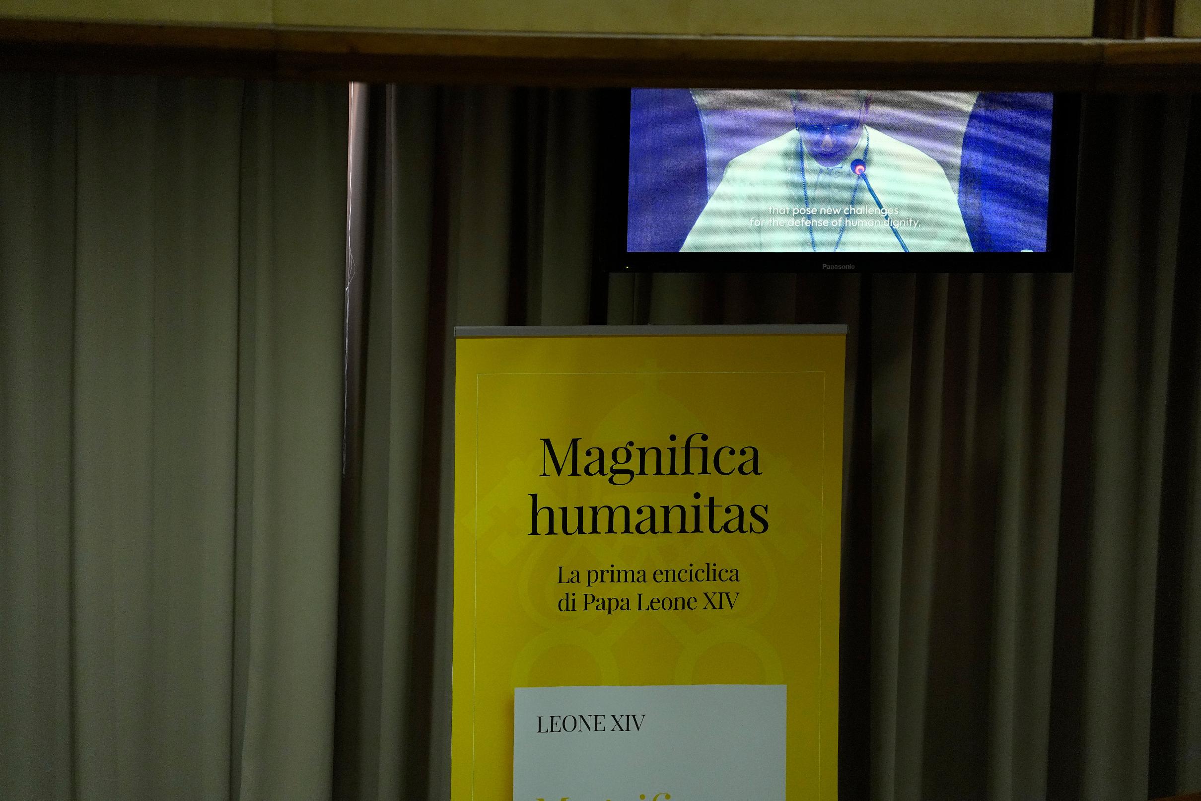 Pope Leo XIV, left, attends the presentation of his first encyclical, "Magnifica humanitas: On Safeguarding the Human Person in the Time of Artificial Intelligence," at the Vatican, Monday, May 25, 2026. (AP Photo/Alessandra Tarantino)