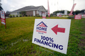 FILE - A sign promoting 100% financing is displayed outside a model home in the Colony Ridge development in Cleveland, Tx., Oct. 3, 2023. (AP Photo/David J. Phillip, File)