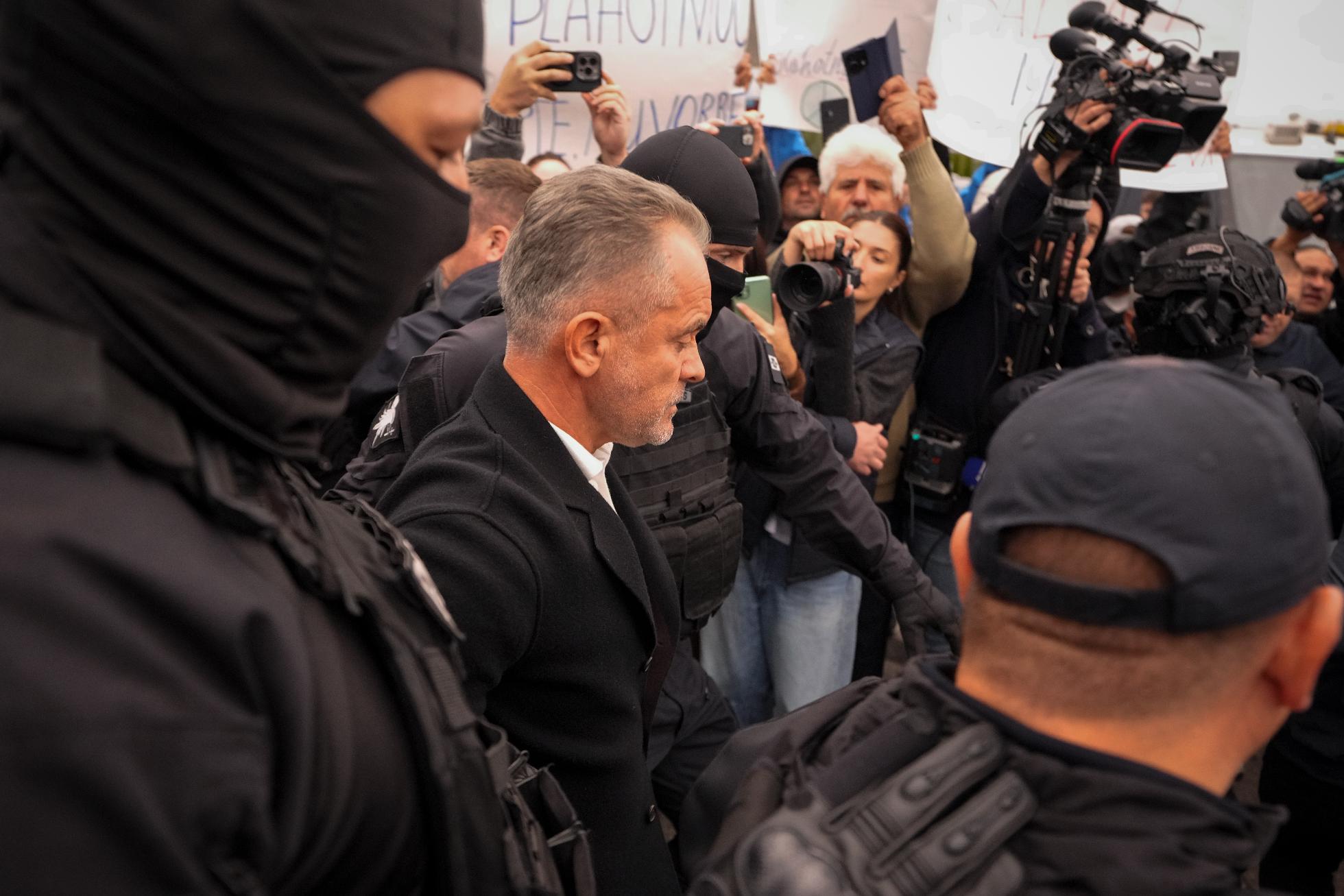 FILE - Vladimir Plahotniuc, a Moldovan oligarch, is escorted by police, after being extradited from Greece, at the Eugen Doga International Airport in Chisinau, Moldova, on Sept. 25, 2025. (AP Photo/Vadim Ghirda, File)
