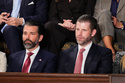 Donald Trump Jr. and Eric Trump listen to President Donald Trump's State of the Union address to a joint session of Congress in the House chamber at the U.S. Capitol in Washington, Tuesday, Feb. 24, 2026. (AP Photo/Alex Brandon)
