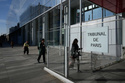 People walks in front of the Paris courthouse, in Paris, France, Monday, April 20, 2026. (AP Photo/Michel Euler)