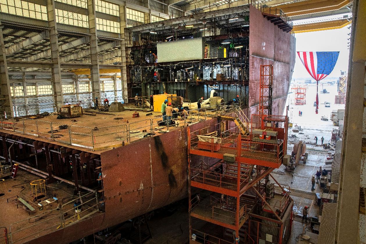 Crews work on the 260-foot-long Eco Edison ship in Terrebonne Parish, La., along the Houma Navigation Canal, Monday, April 3, 2023. The ship will serve as a floating housing for U.S. offshore wind technicians and a warehouse for their tools as they operate and maintain wind farms. (AP Photo/Ted Jackson)