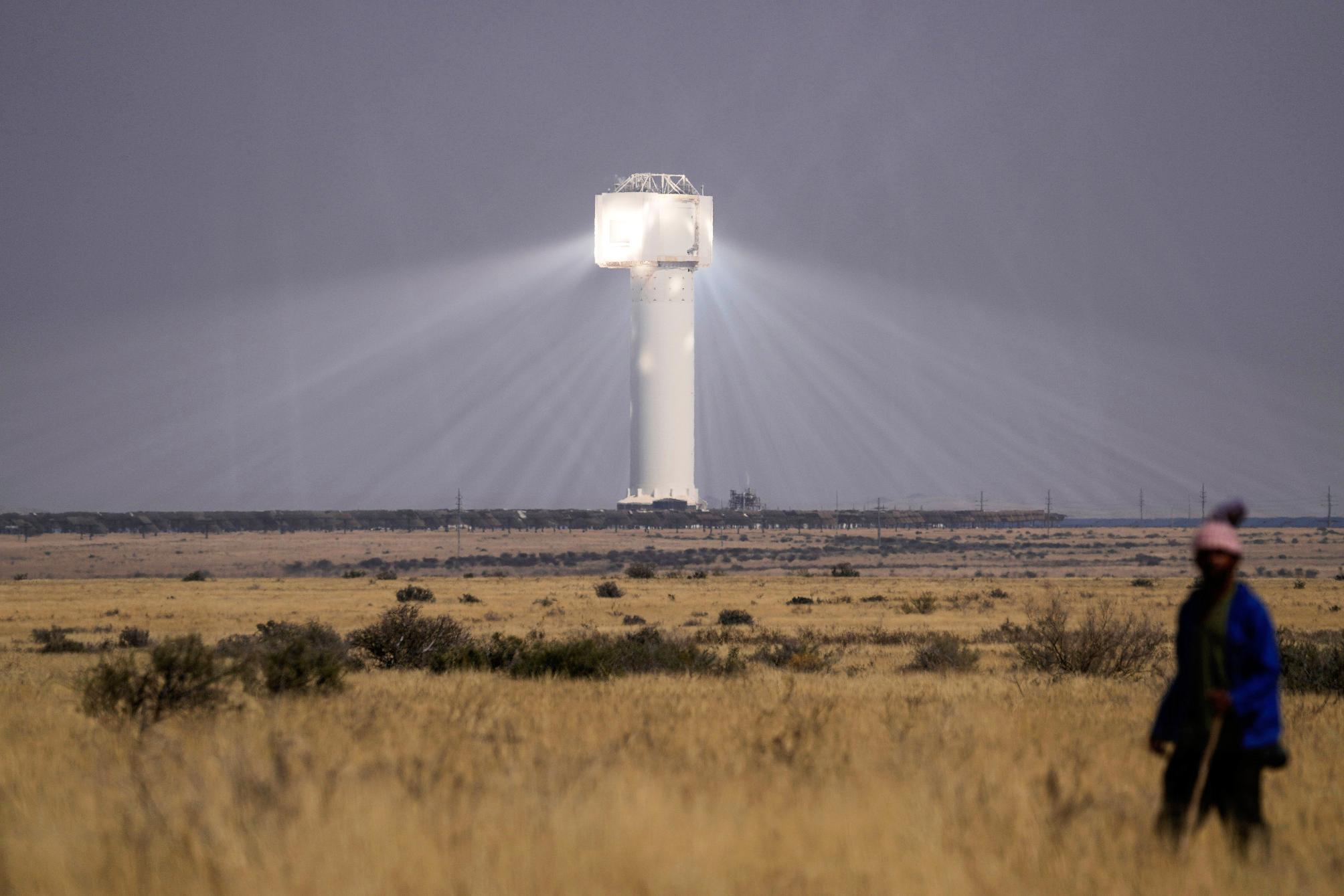 FILE - A shepherd watches livestock near Khi Solar One, a solar thermal plant that converts the sun's light energy into electricity, outside Upington, South Africa, in the Northern Cape province, Aug. 29, 2025. (AP Photo/Themba Hadebe, File)
