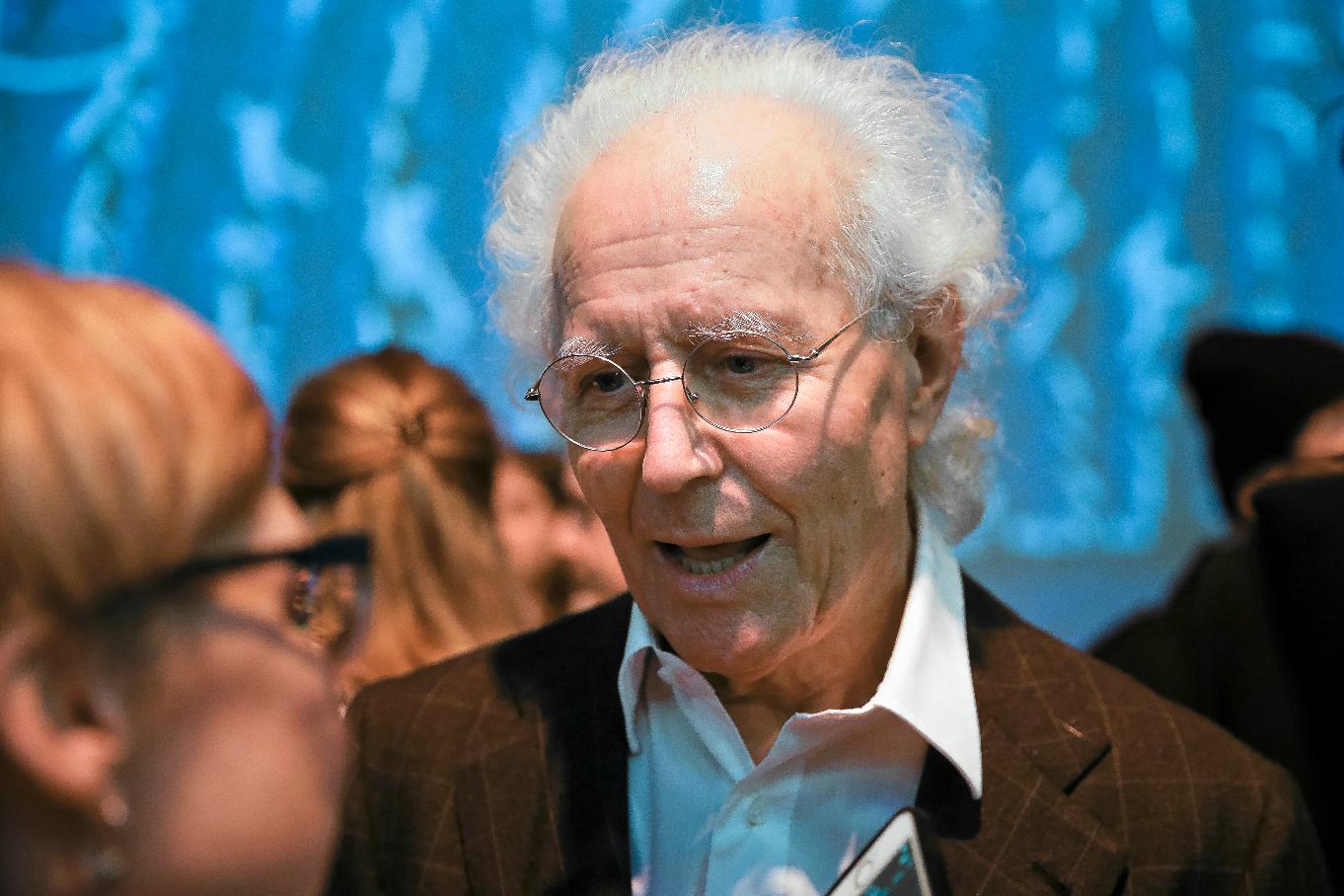 FILE - Luciano Benetton speaks to guests after the Benetton women's Fall-Winter 2019-2020 collection, that was presented in Milan, Italy, on Feb.19, 2019. Benetton, a co-founder of the apparel brand, announced he was stepping down as chairman in an interview Saturday May 25, 2024 with the Milan daily Corriere della Sera where he blamed current management for losses of 100 million euros ($108.5 million) that he discovered last year. (AP Photo/Luca Bruno, File)