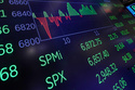 A chart above the trading floor of the New York Stock Exchange displays an intraday number for the SPY, tracking the S&P 500, Friday, Feb. 13, 2026. (AP Photo/Richard Drew)