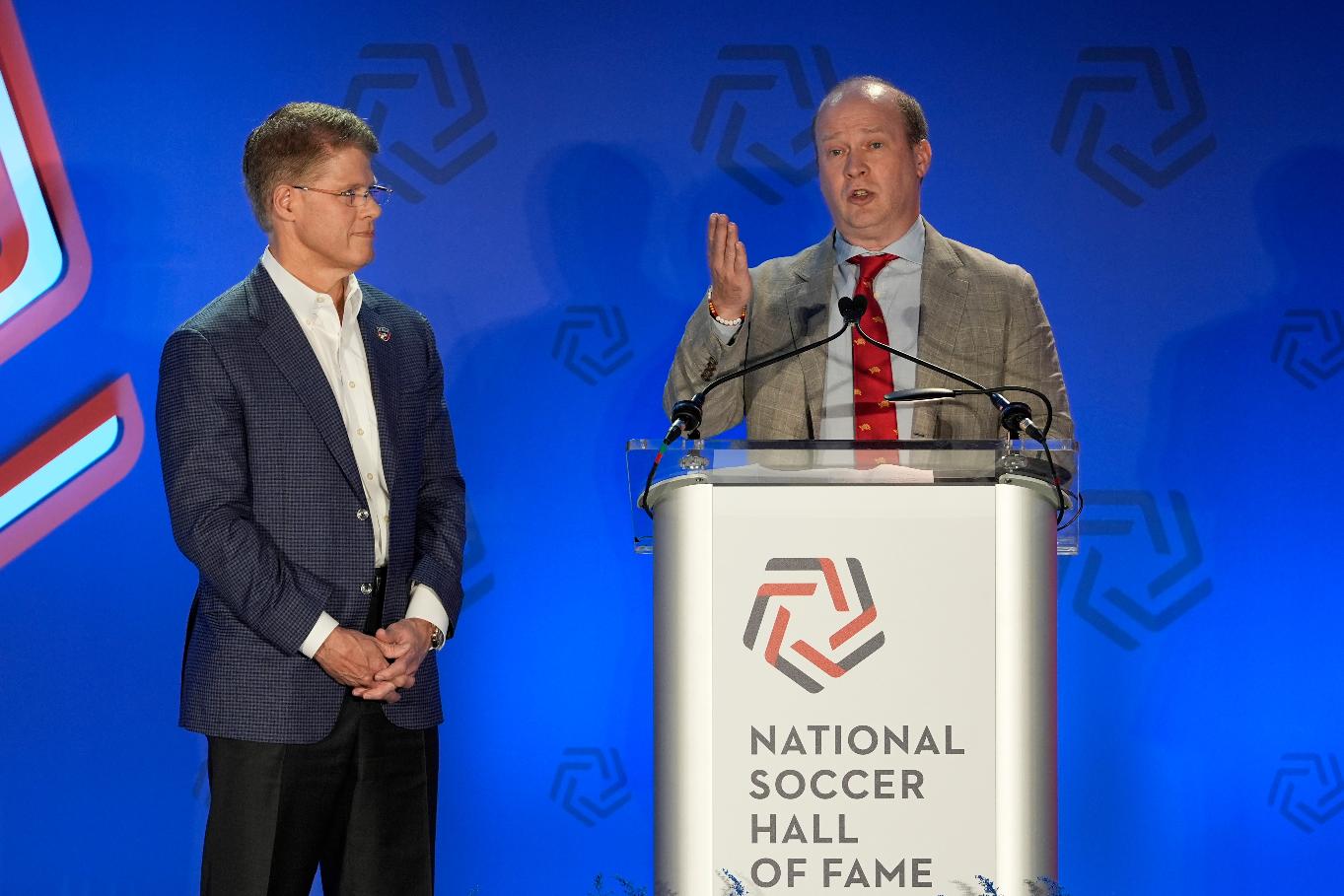 FILE - FC Dallas chairman and CEO Clark Hunt, left, looks on as Dan Hunt, president, FC Dallas, speaks during an induction ceremony for the National Soccer Hall of Fame, May 4, 2024, in Frisco, Texas. (AP Photo/Tony Gutierrez, File)
