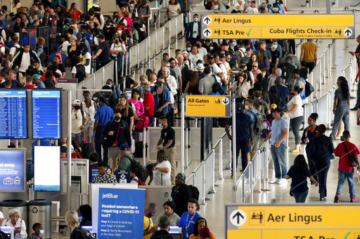 FILE - People wait in a TSA line at the John F. Kennedy International Airport on June 28, 2022, in New York. Tens of thousands of flyers had their travel plans upended Friday, Aug. 5, after airlines canceled more than 1,100 flights for a second straight day because of thunderstorms hitting the East Coast. (AP Photo/Julia Nikhinson, File)