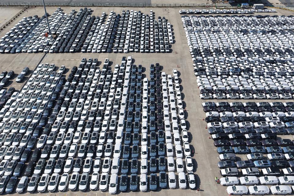FILE -An aerial view of new cars awaiting export to oversea markets is seen at a port in Shanghai, March 10, 2026. (Chinatopix via AP, File)