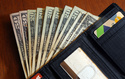 FILE - Cash is fanned out from a wallet in North Andover, Mass, June 15, 2018. (AP Photo/Elise Amendola, File)